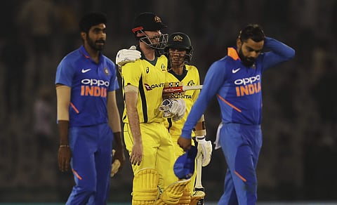 India's captain Virat Kohli, right, reacts as Australia's Ashton Turner and Jhye Richardson smile while walking back to the pavilion after winning the fourth one day international cricket match against India in Mohali, India, Sunday, March 10, 2019. | AP