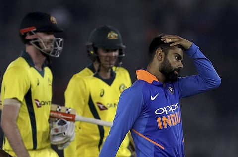 India's captain Virat Kohli, right, reacts as he leaves the ground after loosing to Australia during the fourth one day international cricket match against India in Mohali, India, Sunday, March 10, 2019. | AP