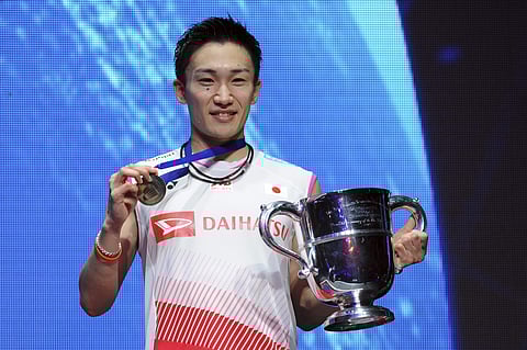 Kento Momota of Japan poses with his trophy after defeating Viktor Axelsen of Denmark in the Men's Singles final match at the All England Open Badminton tournament in Birmingham. (Photo | AP)