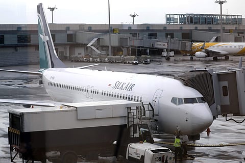 In this Oct. 4, 2017, file photo, SilkAir's new Boeing 737 Max 8 aircraft is seen through a viewing gallery window parked on the tarmac of Singapore's Changi International Airport. (Photo | AP)