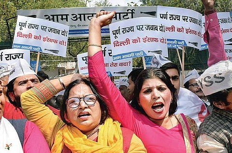 Aam Aadmi Party members raise slogans during a protest against the Congress outside the party’s state unit office in New Delhi on Monday | PTI