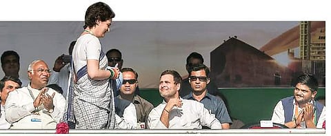 Priyanka walks towards the podium to address the rally as Rahul Gandhi and others look on | PTI