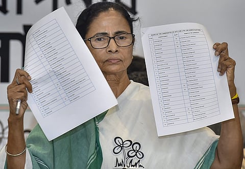 West Bengal Chief Minister and TMC Chief Mamata Banerjee shows the candidates' list for upcoming Lok Sabha election 2019 in Kolkata on 12 March 2019. (Photo | PTI)