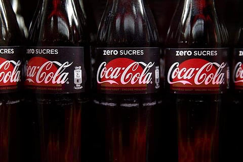 Bottles of Coca-Cola are pictured in a cooler during a news conference in Paris.