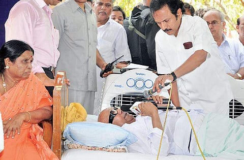 File picture of MK Stalin helping his father M Karunanidhi when the latter was on a fast at Anna Square in Chennai to protest over the Sri Lankan issue in 2009. | Express