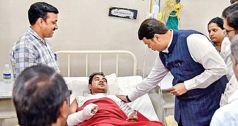 Maharashtra Chief Minister Devendra Fadnavis visits an injured victim of the bridge collapse on 15 March 2019. (Photo | PTI)