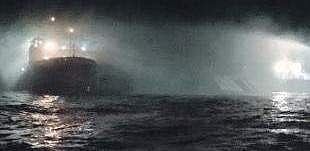 A Coast Gurad ship dousing the fire on board the vessel Sagar Sampada.
