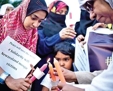 Woman and children participate in a candlelight vigil for those killed in the mass shooting in New Zealand, at Necklace Road on Saturday  | express/ vinay Madapu