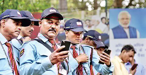 Security guards listen to PM Narendra Modi’s address as part of the ‘Main Bhi Chowkidar’ campaign in Delhi on Wednesday | Shekhar yadav