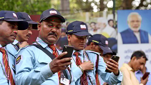 Security guards listening to Prime minister Narendra Modi's radio show in New Delhi. (Photo | Shekhar Yadav, EPS)