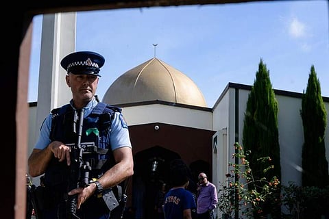 A policeman guards the Al Noor mosque premises as members of the public walk within the mosque grounds in Christchurch. (AFP photo)