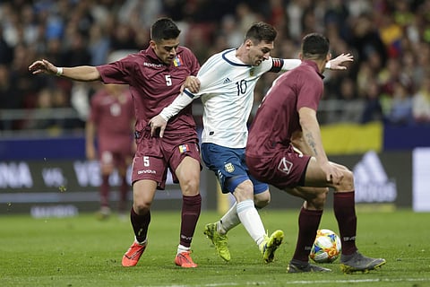 Argentina's Lionel Messi fights for the ball with Venezuela's Junior Moreno (L) and Yordan Osorio (R) during the international friendly match (Photo | AP)