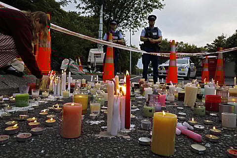 FILE - In this March 18, 2019, file photo, a student lights candle during a vigil to commemorate victims of March 15 shooting, outside the Al Noor mosque in Christchurch, New Zealand. (Photo | AP)