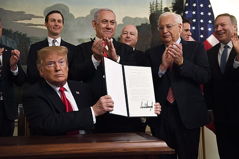 President Donald Trump holds up a signed proclamation recognizing Israel's sovereignty over the Golan Heights, as Israeli Prime Minister Benjamin Netanyahu looks on in the Diplomatic Reception Room of the White House in Washington. (Photo | AP)