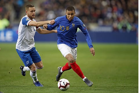 France's Kylian Mbappe, right, challenges for the ball with Iceland's Sverrir Ingason during the Euro 2020 group H qualifying soccer match between France and Iceland at the Stade de France in Saint Denis, north of Paris. (Photo  | AP)