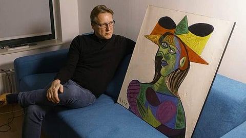 Dutch art detective Arthur Brand posing with stolen Picasso painting “Buste de Femme (Dora Maar)” on 14 March, 2019 at his Amsterdam home. (Photo | AFP)
