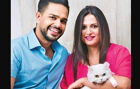 Pratiksha Kataria Ahuja with her husband and their cat.