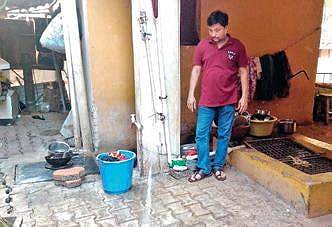 A local pointing out contaminated water at his home | express