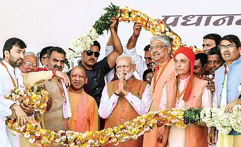PM Narendra Modi being garlanded by BJP leaders and workers during ‘Vijay Sankalp Rally’ in Meerut on Thursday. (Photo | PTI)