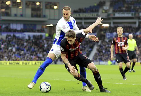 Brighton's Glenn Murray, left and Huddersfield Town's Erik Durm battle for the ball, during the English Premier League soccer match between Brighton and Huddersfield Town, at the AMEX Stadium, in Brighton, England, Saturday, March 2, 2019. | AP