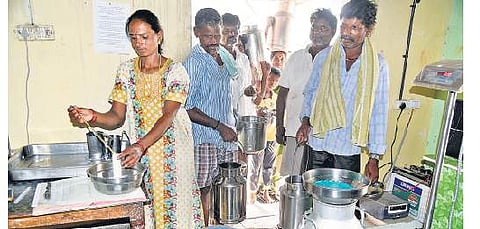 Farmers depositing milk at a dairy cooperative society at Ragihalli on the outskirts of Bengaluru city. | Nagaraja Gadekal