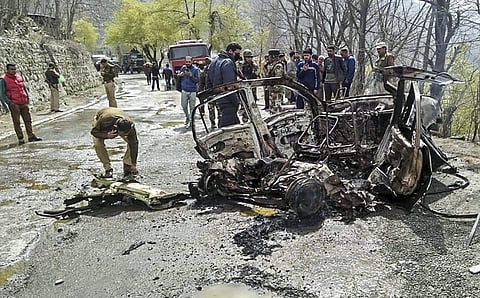 Ramban Security personnel inspect the mangled remains of a car which exploded near a CRPF convoy on the Jammu-Srinagar highway at Banihal in Ramban district of Jammu and Kashmir on March 30, 2019. (Photo | PTI)