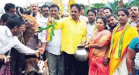 TDP city president and MLA Vasupalli Ganesh Kumar take part in the ‘suddhi rituals’ at the YSRC Maha Dharna venue  at Gandhi statue near GVMC in Visakhapatnam on Thursday (Photo | Express Photo)