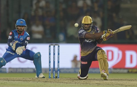 Rishabh Pant keeps as KKR's Andre Russell plays a shot. (Photo | PTI)