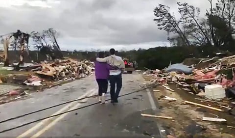 People walk amid debris in Lee County, Ala., after what appeared to be a tornado struck in the area Sunday, March 3, 2019. (Photo | AP)