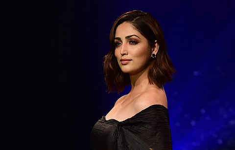 Actress Yami Gautam walks the ramp to showcase works of designer Rina Dhaka during a fashion show in Bengaluru. | PTI