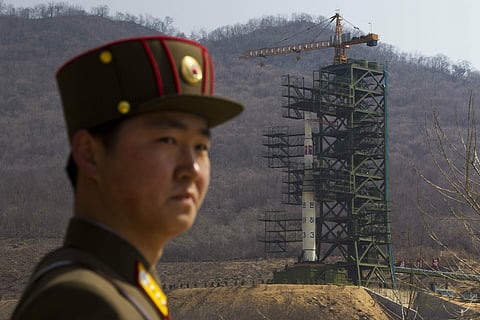 In this April 8, 2012, file photo, a soldier stands in front of the Unha-3 rocket at a launching site in Tongchang-ri, North Korea. North Korea is reportedly restoring facilities at its long-range rocket launch site that it had dismantled as part of disar