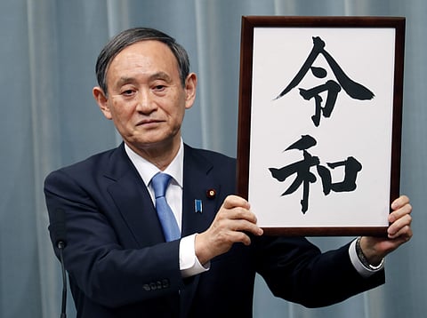Japan’s Chief Cabinet Secretary Yoshihide Suga unveils the name of new era “Reiwa” at the prime minister’s office in Tokyo. (Photo | AP)
