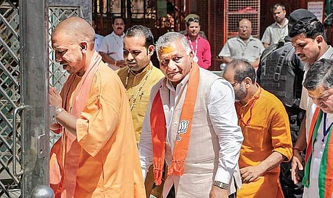 UP CM Yogi Adityanath with BJP candidate VK Singh visits a temple in Ghaziabad on Sunday  | Pti
