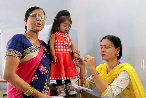World's shortest woman Jyoti Amge 25 gets her finger marked with indelible ink after casting vote during the first phase of general elections at a polling station in Nagpur Thursday April 11 2019. | PTI