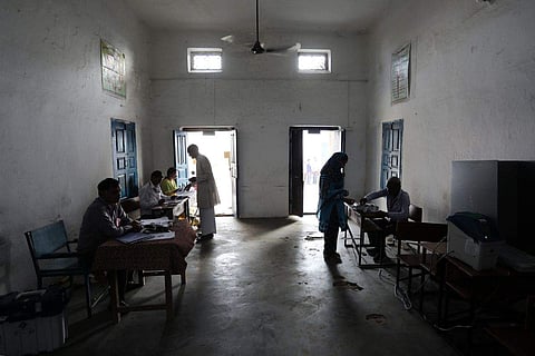 Voters prepare to vote at a polling station during the first phase of voting for national elections in Muzaffarnagar district, Uttar Pradesh, India, on April 11. (Bloomberg)