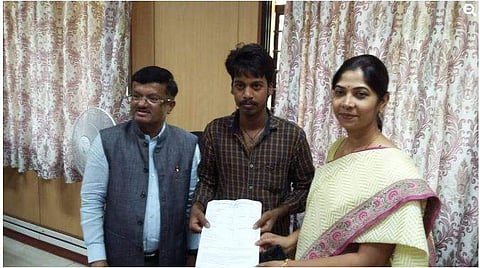 C Shikha, Director, Department of Pre-University Education congratulate Dhananjaya for his results in PUC II exams (Photo | edexlive.com)