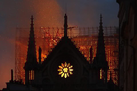 Flames and smoke rise from Notre Dame cathedral as it burns in Paris. (Photo | AP)