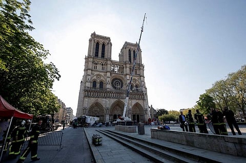 A crane works on a facade at the Notre-Dame Cathedral after the fire incident (Photo| AFP)