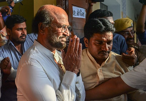 Tamil superstar Rajinikanth greets his fans after casting his vote in Chennai. (Photo | PTI)