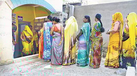 Women voters stand in line at Government Urdru School in Kengeri to go get inked. | Vinod kumar t, pushkar v