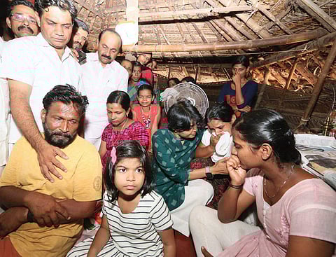 UDF Ernakulam candidate Hibi Eden and family consoling Kripesh’s family in their hut on Friday. They moved into the house Hibi built for them at Kalliyot the same day