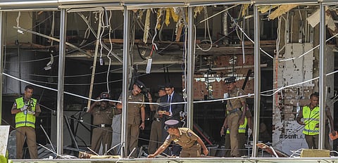 A Sri Lankan Police officer inspects a blast spot at the Shangri-la hotel in Colombo, Sri Lanka. (Photo | AP)