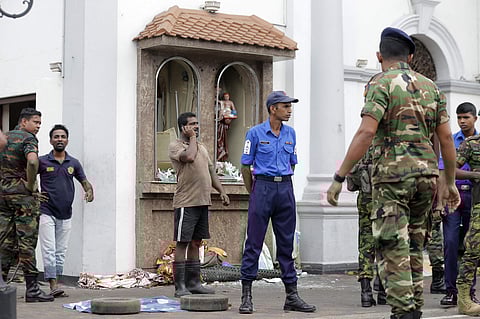 People gather outside St. Anthony's Shrine where a blast happened, in Colombo, Sri Lanka. (Photo | AP)