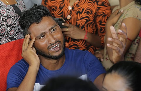 A Sri Lankan man cries while looking for the bodies of his family members killed in yesterday church blasts in a mortuary in Colombo (Photo | AP)