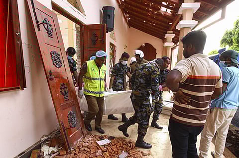 Sri Lankans carry a dead body at St. Sebastian's Church damaged in blast in Negombo, north of Colombo, Sri Lanka, Sunday, April 21, 2019. | AP