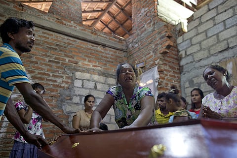 Lalitha, center, weeps over the coffin with the remains of 12-year old niece, Sneha Savindi, who was a victim of Easter Sunday bombing at St. Sebastian Church, in Negombo, Sri Lanka, on 22 April, 2019. (Photo | AP)