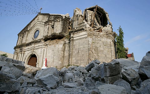 The damage of St. Catherine church, with its headless statue, is seen following a 6.1 magnitude earthquake that also caused the collapse of a commercial building in Porac township in north Philippines (Photo|AP)