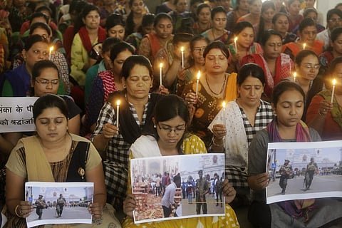Indian staff at a school pray for the victims of Sunday's blasts in Sri Lanka, in Ahmadabad, India, on 22 April 2019. (Photo | AP)