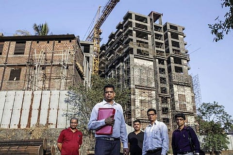 Home owners at their unfinished apartment building in Mumbai. (Photo | Bloomberg)