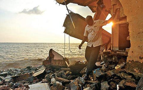 Stephen Benny searching valuables in the house after coming to know about that his house was destroyed following sea erosion  at Valiathura  B P Deepu
